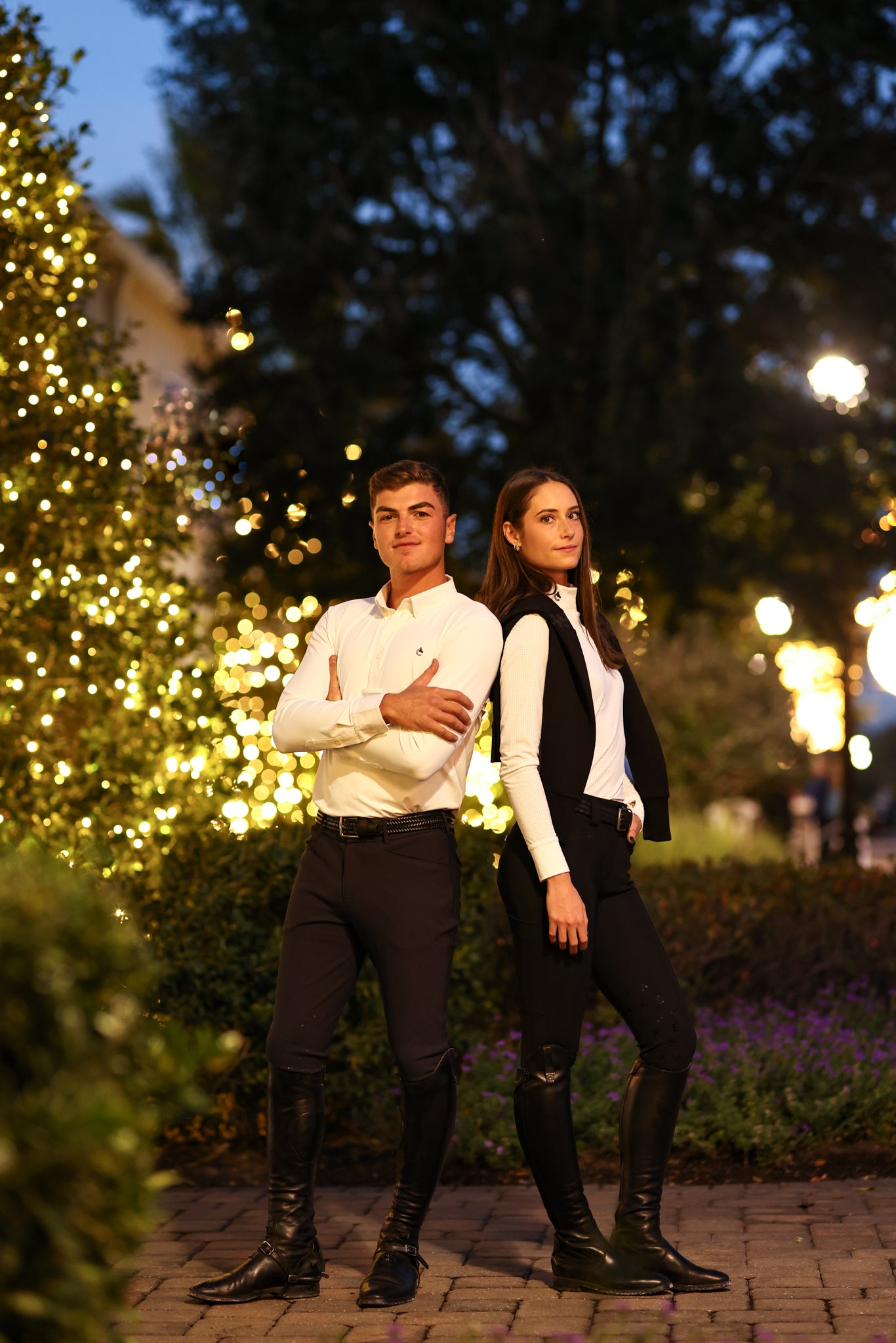 Two people standing in front of the World Equestrian Center building.
