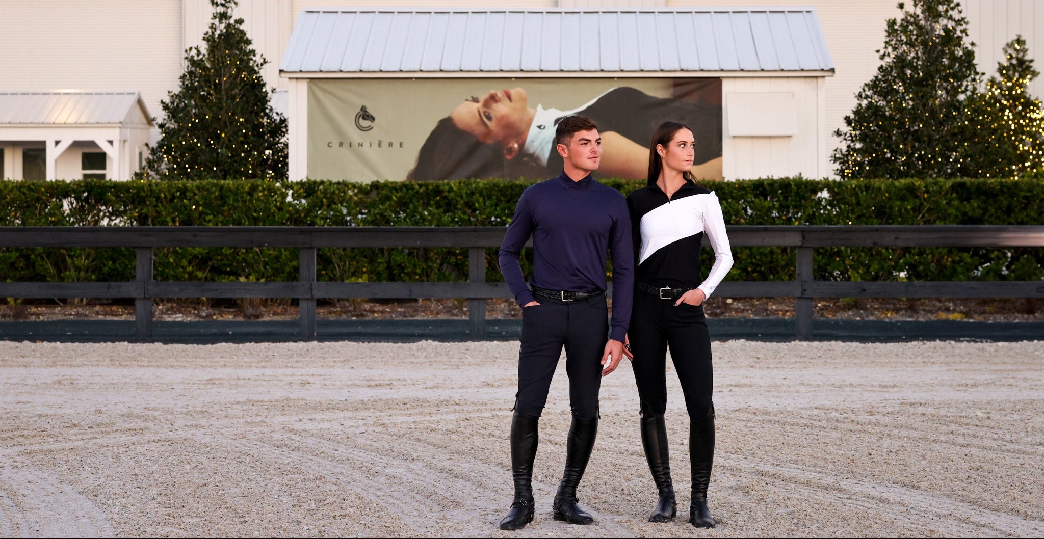 Two people standing in front of the World Equestrian Center building.